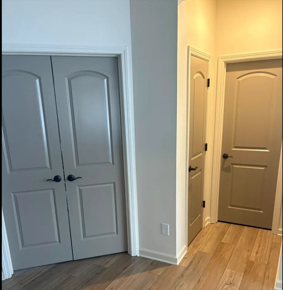 Interior accent doors painted gray and taupe with crisp white trim