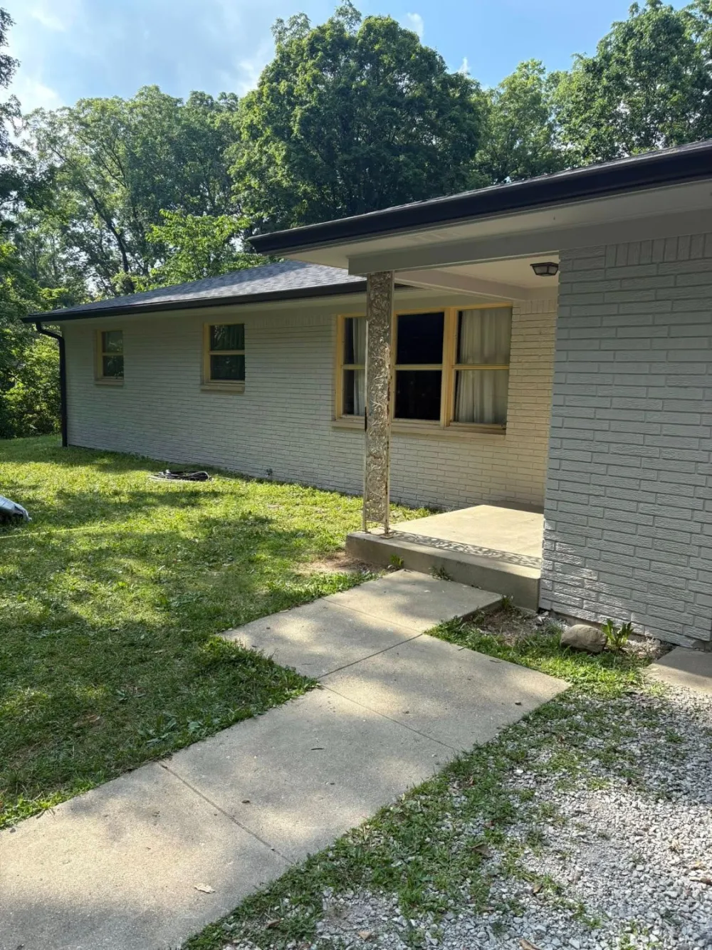 1950s brick home exterior painted white — modernized and refreshed