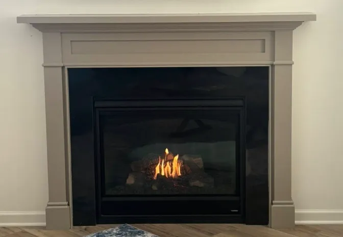 Fireplace mantel surround painted in warm greige — from dated brick to a clean modern finish